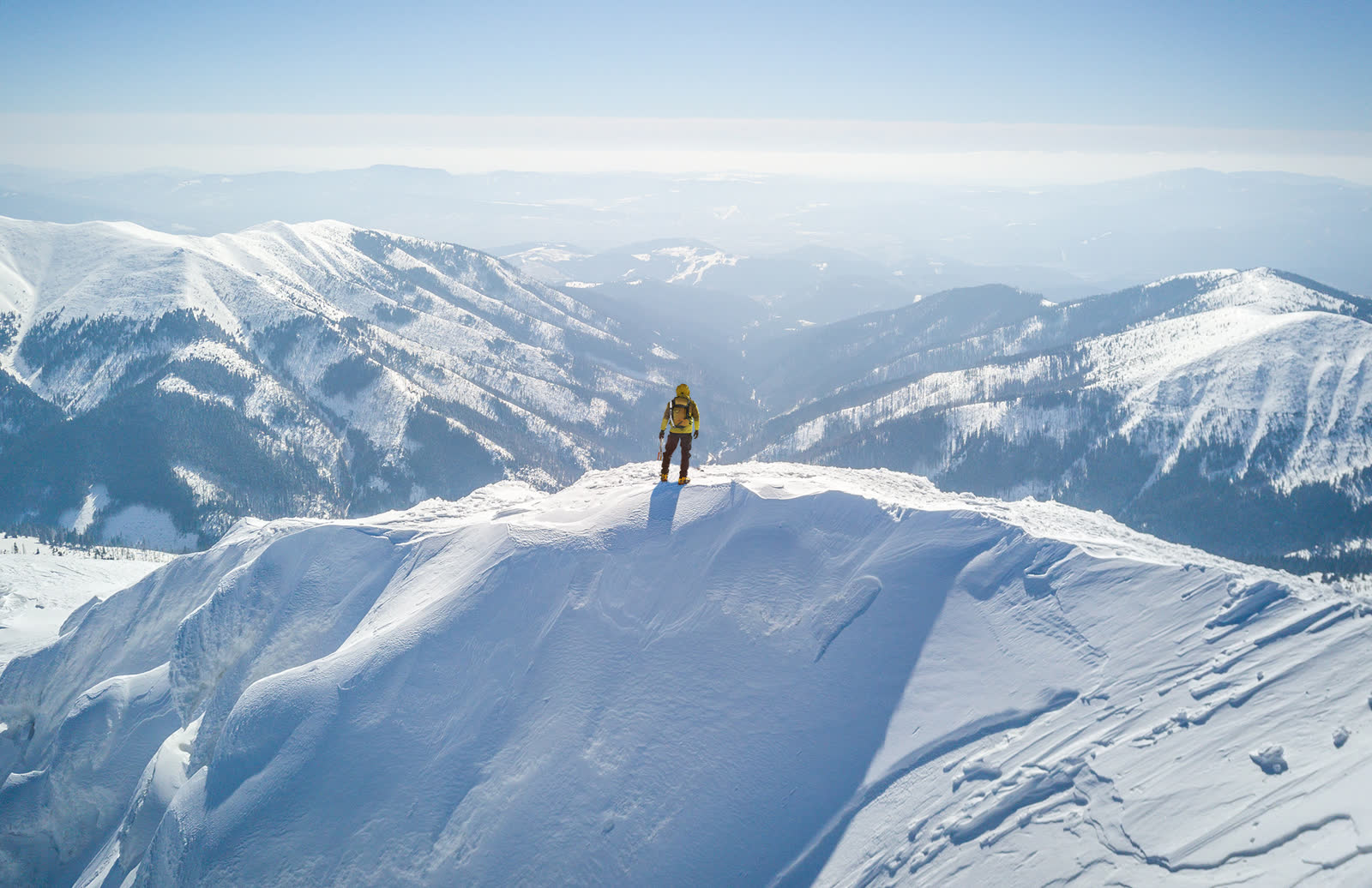 Person climbing a snowy mountain